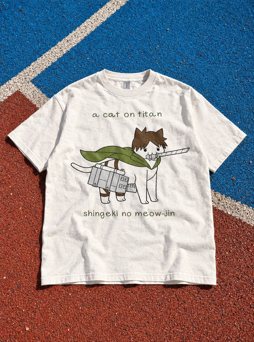 A Cat on Titan – White Tee – flat-lay | Meme Tees